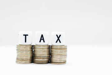 Tax Season: TAX Spelled with Dice placed in the picture of  White Surface and blurred background and foreground digitally generated image stock photo copy space