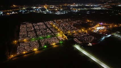 Aerial view of a Polish cemetery on All Saints’ Night, glowing with thousands of candles that...