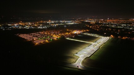 Aerial view of a Polish cemetery on All Saints’ Night, glowing with thousands of candles that...