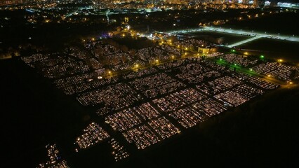 Aerial view of a Polish cemetery on All Saints’ Night, glowing with thousands of candles that...
