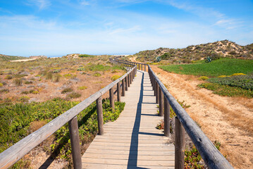 wooden boardwalk in mediterranean dunes landscape, West Algarve Portugal