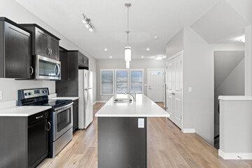 Kitchen with a black island and a white countertop