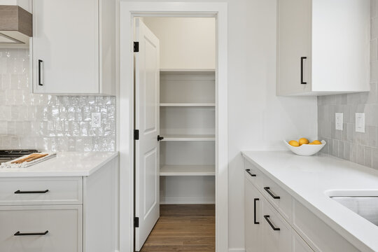 Kitchen with a white door leading to a pantry