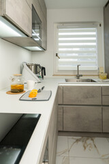 Hot tea with fresh orange slices on table in cozy kitchen. Morning relaxation, healthy beverage,...