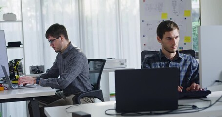 Adult male engineer team discusses AI software development robotic hand project use AI code solutions at tech workspace. Artificial intelligence interface, collaboration support prototype development. - Powered by Adobe