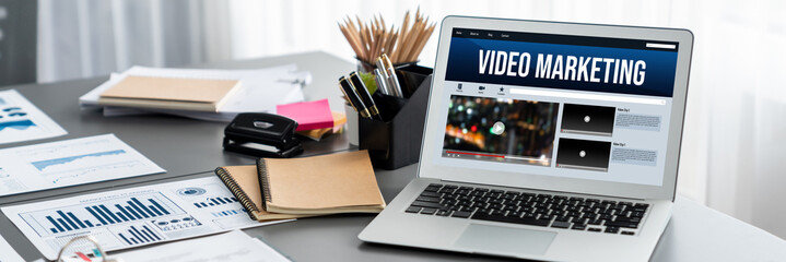 Data analysis dashboard display on laptop screen on office table with financial papers by Fintech...