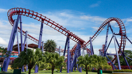 Colorful roller coaster in amusement park under bright sky, symbolizing fun, thrill, and excitement.
