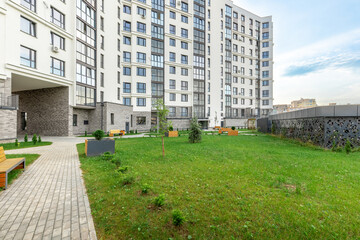 Modern Residential Building with Green Courtyard and Benches