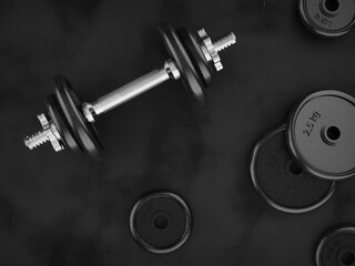 Dumbbell weights on a black