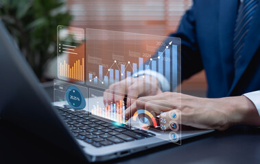Businessman using laptop to analyze performance with business analytics dashboard, charts, metrics, KPIs, and AI-driven insights for operations management and data analysis.