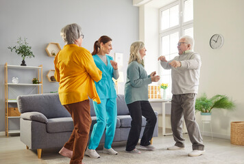 Group of happy and active elderly patients and a nurse dancing and celebrating during a party at a nursing home. Fun, happiness, and the importance of leisure activities for seniors.