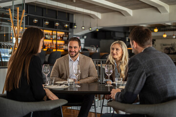 group of friends enjoying a meal together at a restaurant