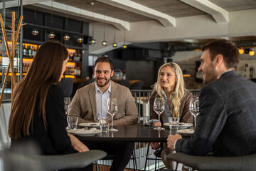 Group of friends enjoying a meal together at a restaurant