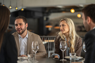Business colleagues having a meeting at a restaurant during lunch break