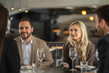 Business colleagues enjoying a meal and conversation at a restaurant