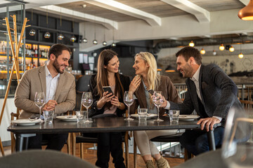 Friends enjoying a meal together at a stylish restaurant
