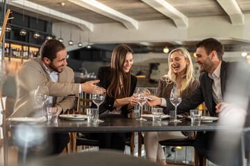 Friends enjoying a meal and conversation at a stylish restaurant