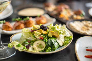 Fresh salad with avocado and other ingredients on a plate, ready to eat
