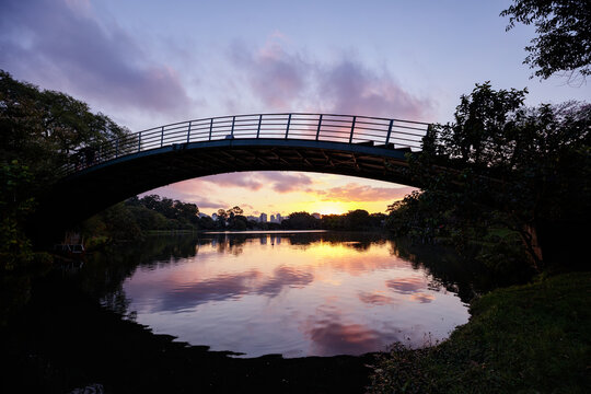 A still image of the iron bridge over the lake in Ibirapuera Park, Sao Paulo, with the sunset.