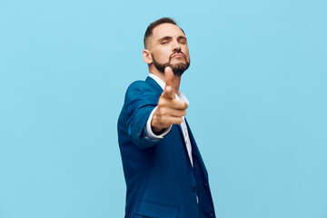 A confident business professional in a blue suit stands against a bright isolated colored backdrop,...