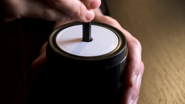 Female hand sticking pencil into automatic electric pencil sharpener and sharpening it close-up side view. Office stationery tool. Preparation for drawing and sketching. High quality 4k footage.