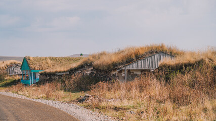 Rustic Grass-Roofed House in a Vast Mountain Landscape