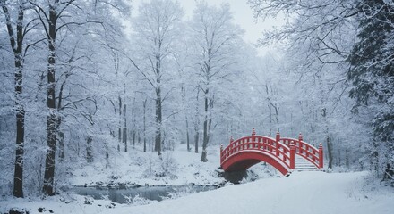 Red bridge in snowy winter park with forest landscape