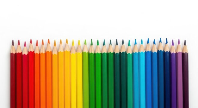 A vibrant array of colored pencils arranged in a spectrum, creating a rainbow effect isolated on white background