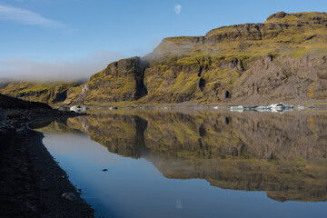 Fototapeta premium Mirror-like lake reflecting the mountains, capturing natural beauty.