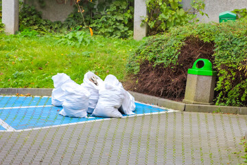 White inflatable swan pool float on blue swimming pool with green grass surroundings in Antalya, Turkey. High quality photograph