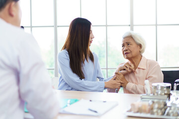 Fototapeta premium Asian woman with senior mother consulting doctor in clinic.
