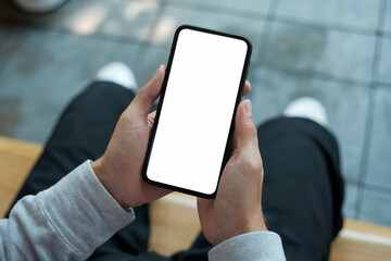 A First-Person Perspective Shot of Hands Holding a Black Smartphone with a White Isolated Screen
