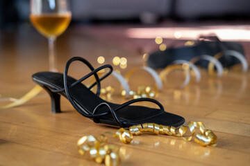 party or after party background birthday wedding Christmas new year  black high-heeled shoes surrounded by festive decorations and a glass of wine, celebratory atmosphere