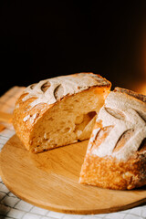 Fresh artisan bread cut open reveals soft texture and crispy crust in a warm setting
