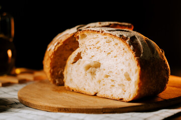 Fresh artisan bread sliced and ready to enjoy on a wooden board