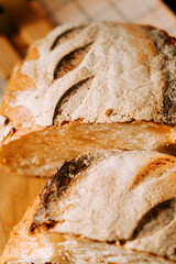 Fresh artisan bread loaves sliced and displayed on a wooden cutting board