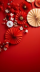 Vibrant red background with festive paper fans and delicate white flowers creating a celebratory chinese new year atmosphere