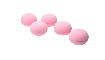 Five soft pink bath bombs aligned on a dark background, showing delicate texture and gentle color, simple still life