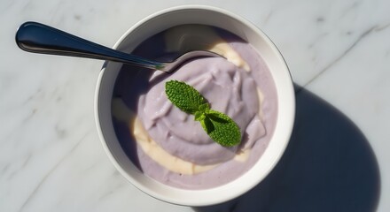 Delicious Bowl Of Purple Creamy Dessert Garnished With Fresh Mint With Natural Light