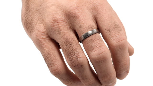 PNG of Close-up of a male hand with a textured metal wedding band, showcasing a rustic charm.