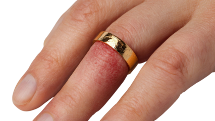 PNG of Close-up of a hand with a gold ring on a finger, highlighting the unique texture and design of the ring against the skin.