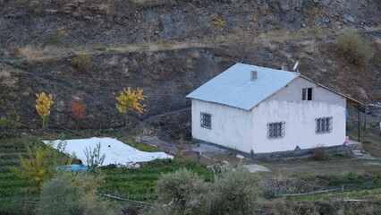 A chalet at the foot of the mountains in autumn.