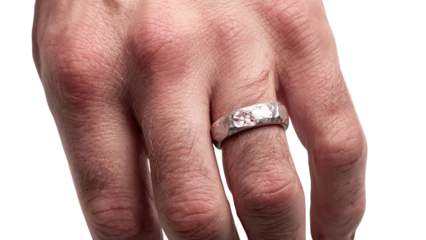 PNG of Close-up of a male hand wearing a unique, textured silver ring.