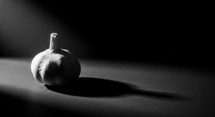 Dramatic Black And White Image Of Garlic Head With Strong Light And Shadow Play