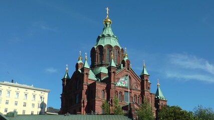 HELSINKI, FINLAND - July 12, 2016: Assumption Cathedral and the bridge of love bright summer day.