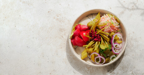 Assorted snacks from fermented cabbage, cucumbers and tomatoes, green bean. Decorated cranberry. Fermented healthy food concept. Pickled cucumbers, marinated tomatoes. Top view or flat lay.