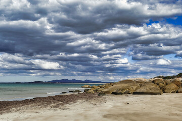 Coastal scenery with granite rocks and spectacular cloudscape at the remote Waterhouse Conservation Area, northeast Tasmania, Australia
