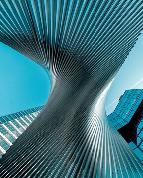 Look up at abstract view of modern metallic skyscraper, Main Tower in Frankfurt, Germany. Geometric architecture design with rhythm, symmetry and minimalism in contemporary urban construction