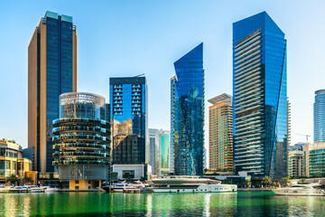 Dubai Marina modern skyscrapers at sunny day. Dubai, United Arab Emirates.
