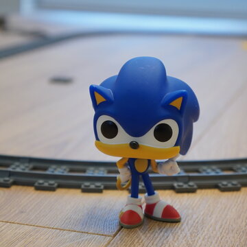 Funko Pop! Sonic the Hedgehog figurine standing on a wooden floor with a toy train track
